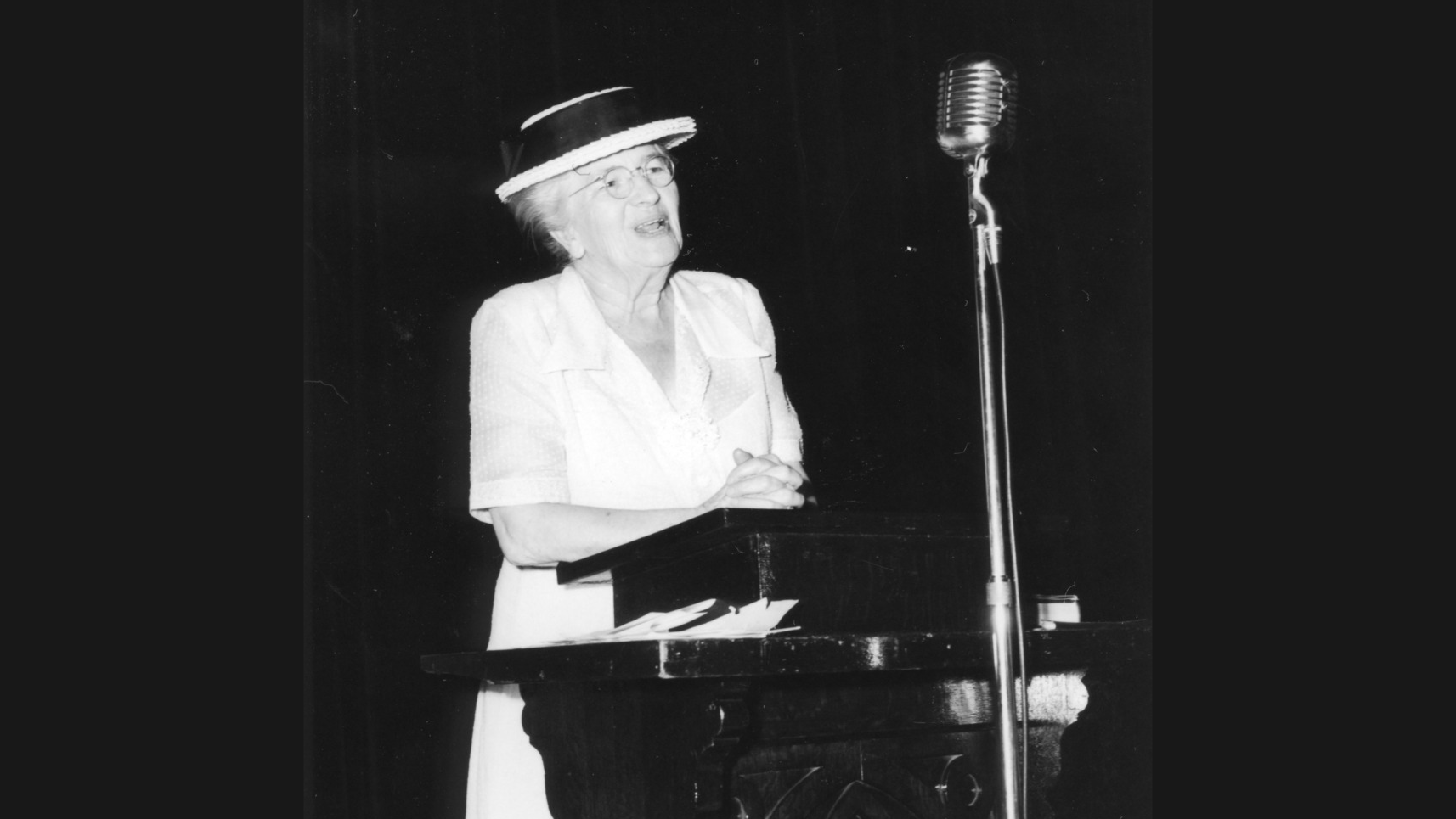 Jane McKimmon stands at the lectern during a conference presentation