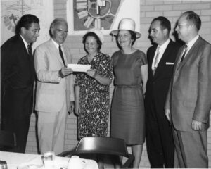 Mrs. Henry Walker presenting donation for McKimmon Extension Education Center to North Carolina State University Chancellor John T. Caldwell, July 1966.; Pictured from left to right: Dr. Jack Suberman, Dr. John T. Caldwell, Mrs. Henry Walker, Dr. Eloise Cofer, Dr. William Turner, and J.T. Outlaw.