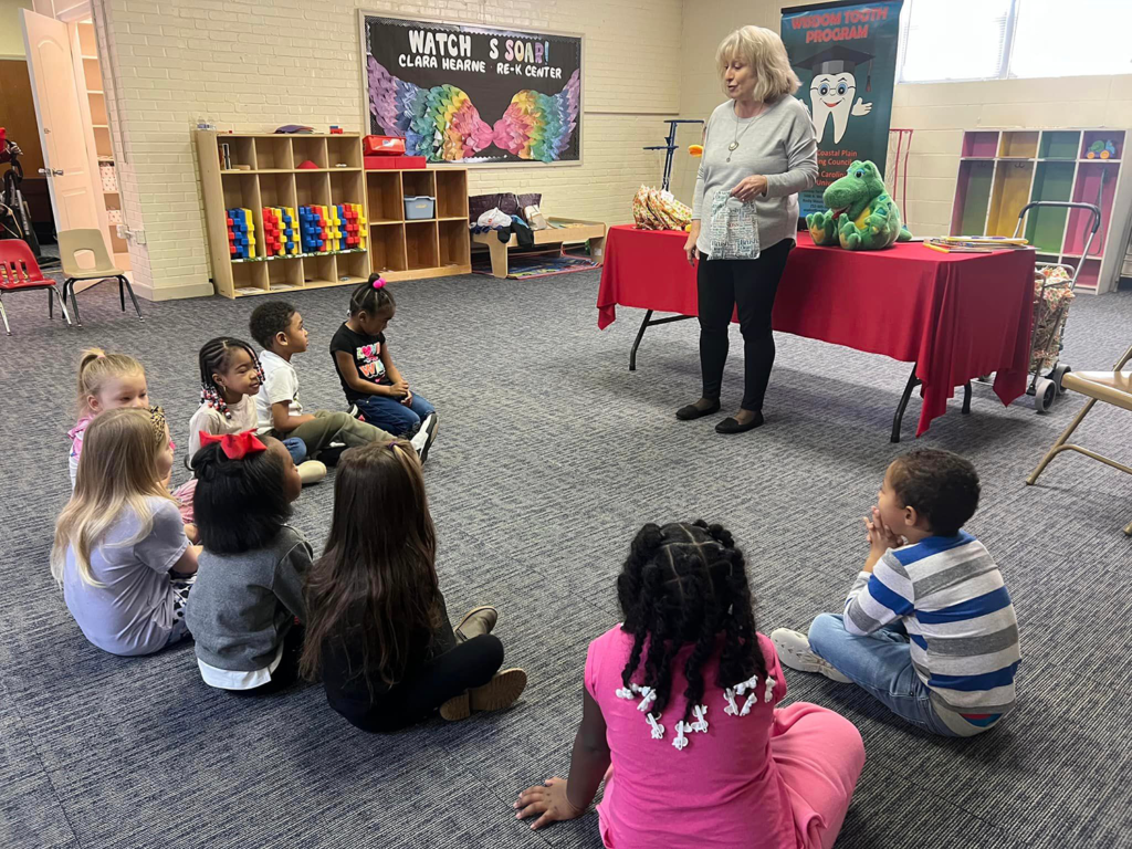 Children learning about dental hygiene through the Wisdom Tooth Program. 