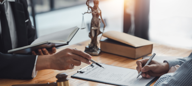A paralegal assisting client with signing documents