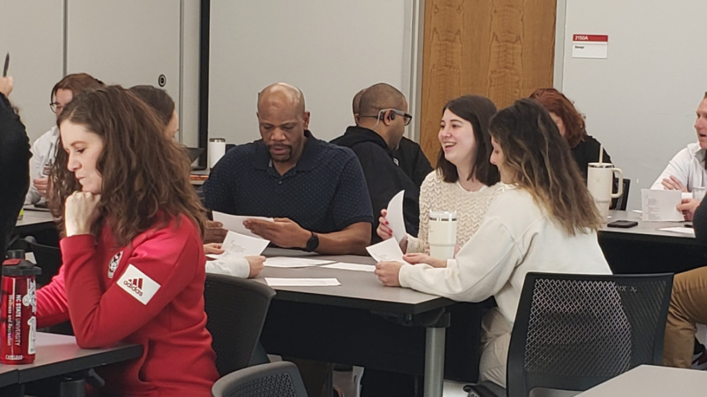 DHHS staff sit in a classroom during training