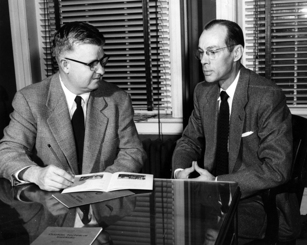 Edward Ruggles and James Mason seated at a desk