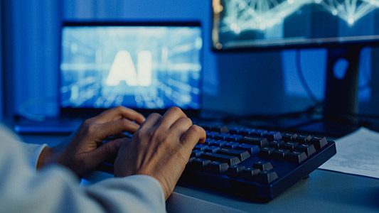 Closeup woman using Generative AI at desk with multiple screens.