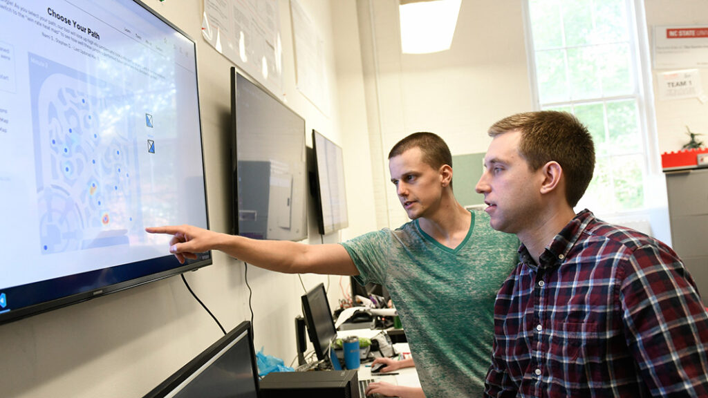 Laber lab student and instructor working on digital gaming maps College of Sciences NC State.