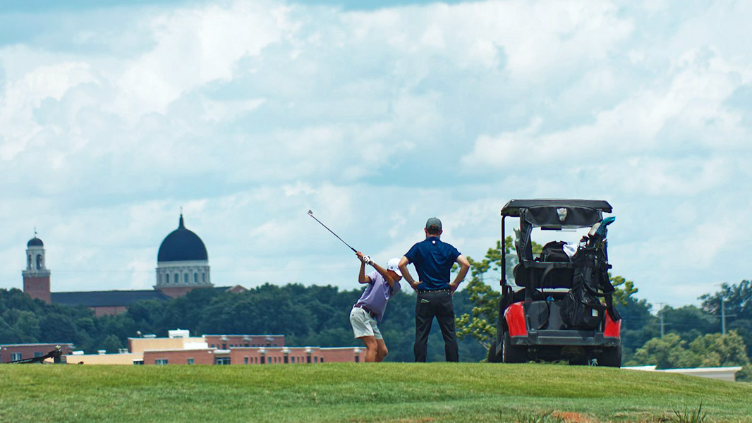Golfer and caddie at the Lonnie Poole Golf Course - NC State University