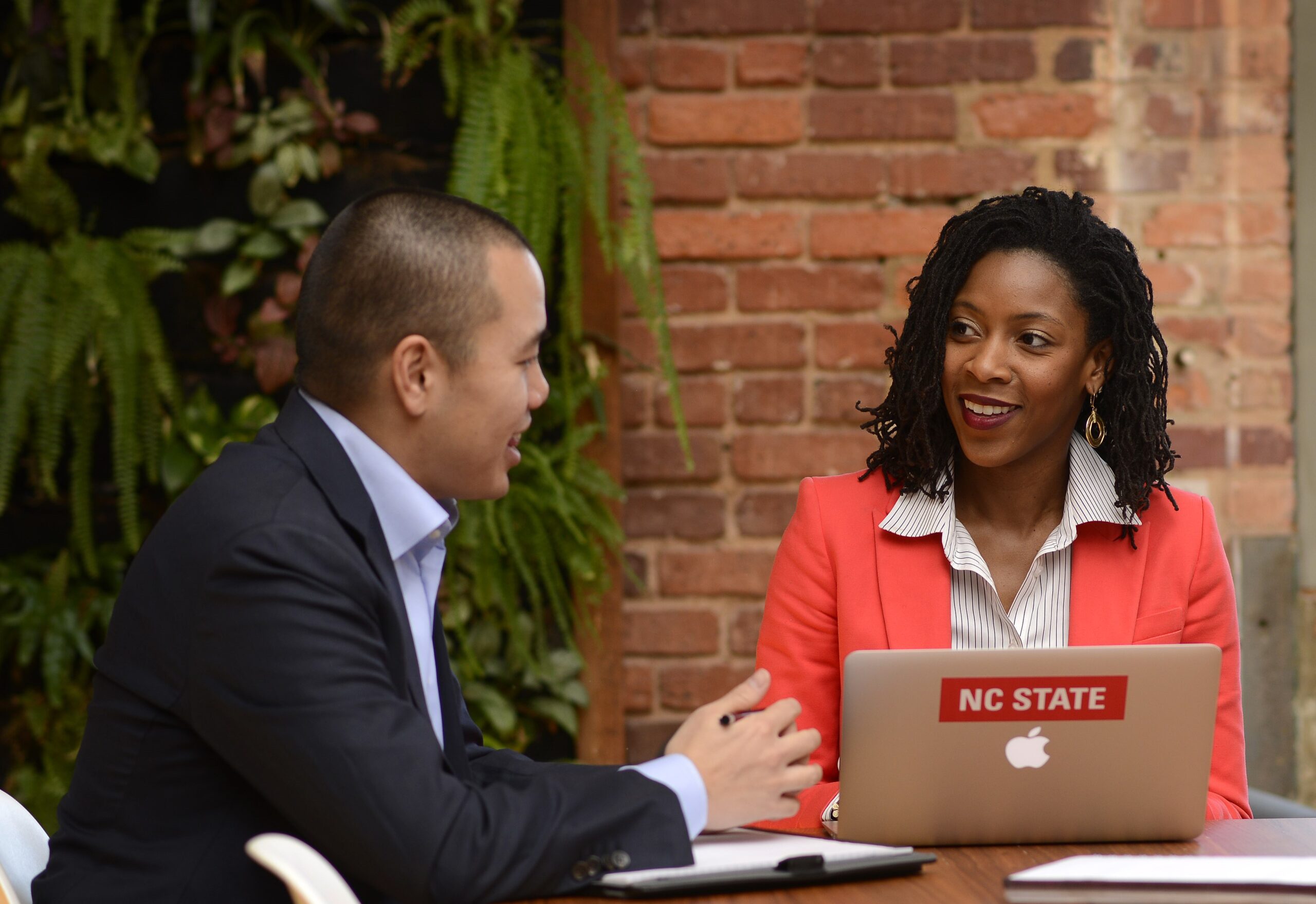 Two people discussing a program