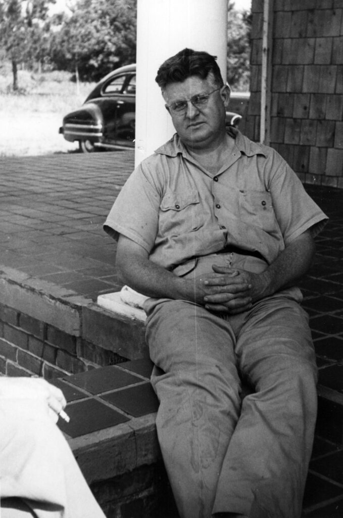 Edward Ruggles sitting on a brick portico