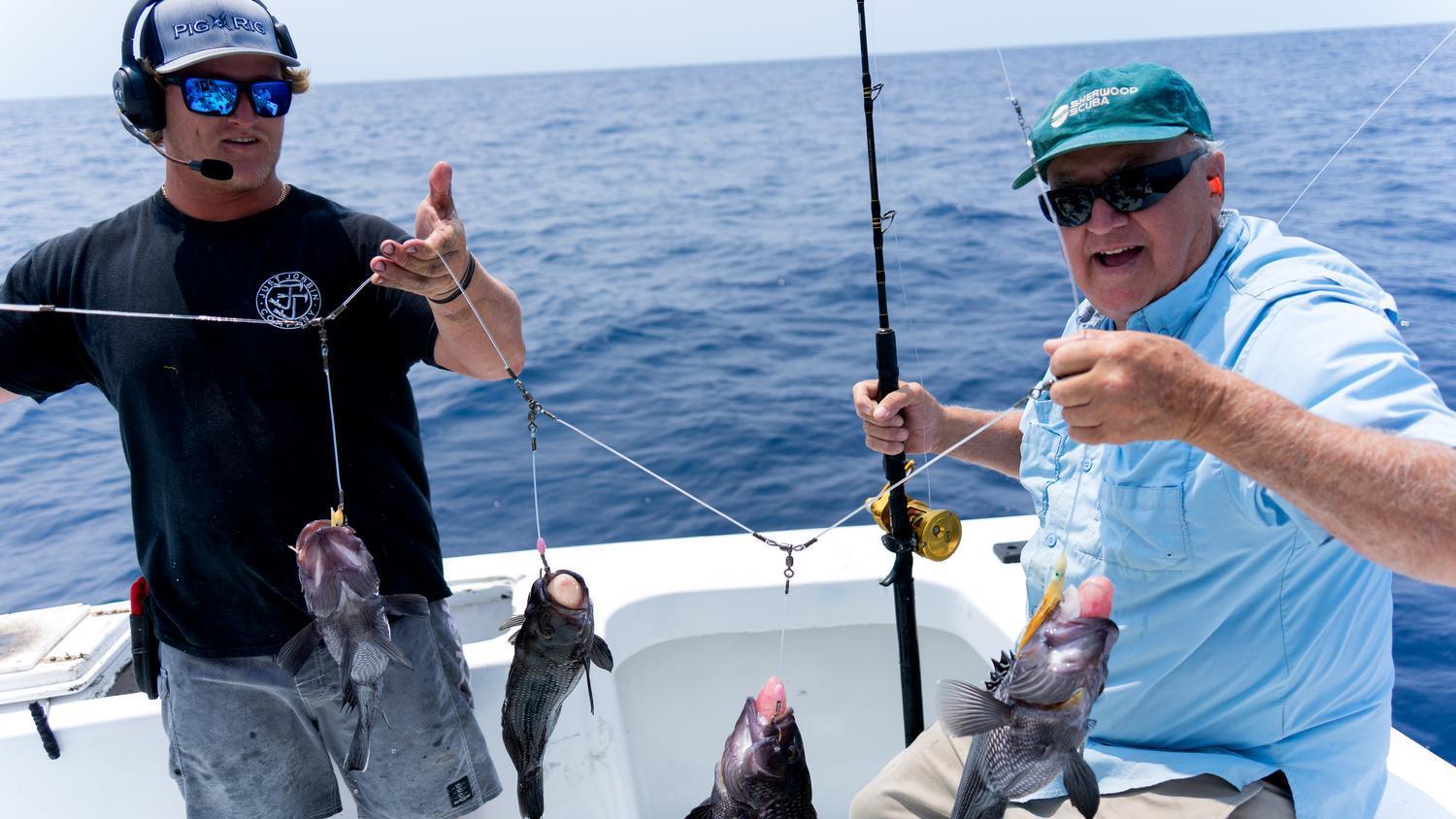 Sport Fishing School - June 2025 - instructor holding up fish with another gentleman