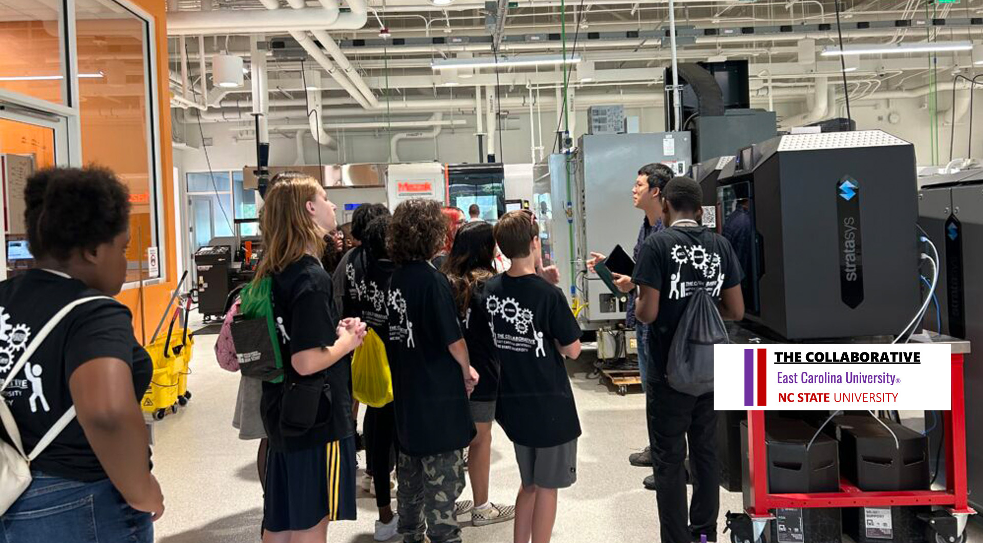 Group of students tour engineering facility.