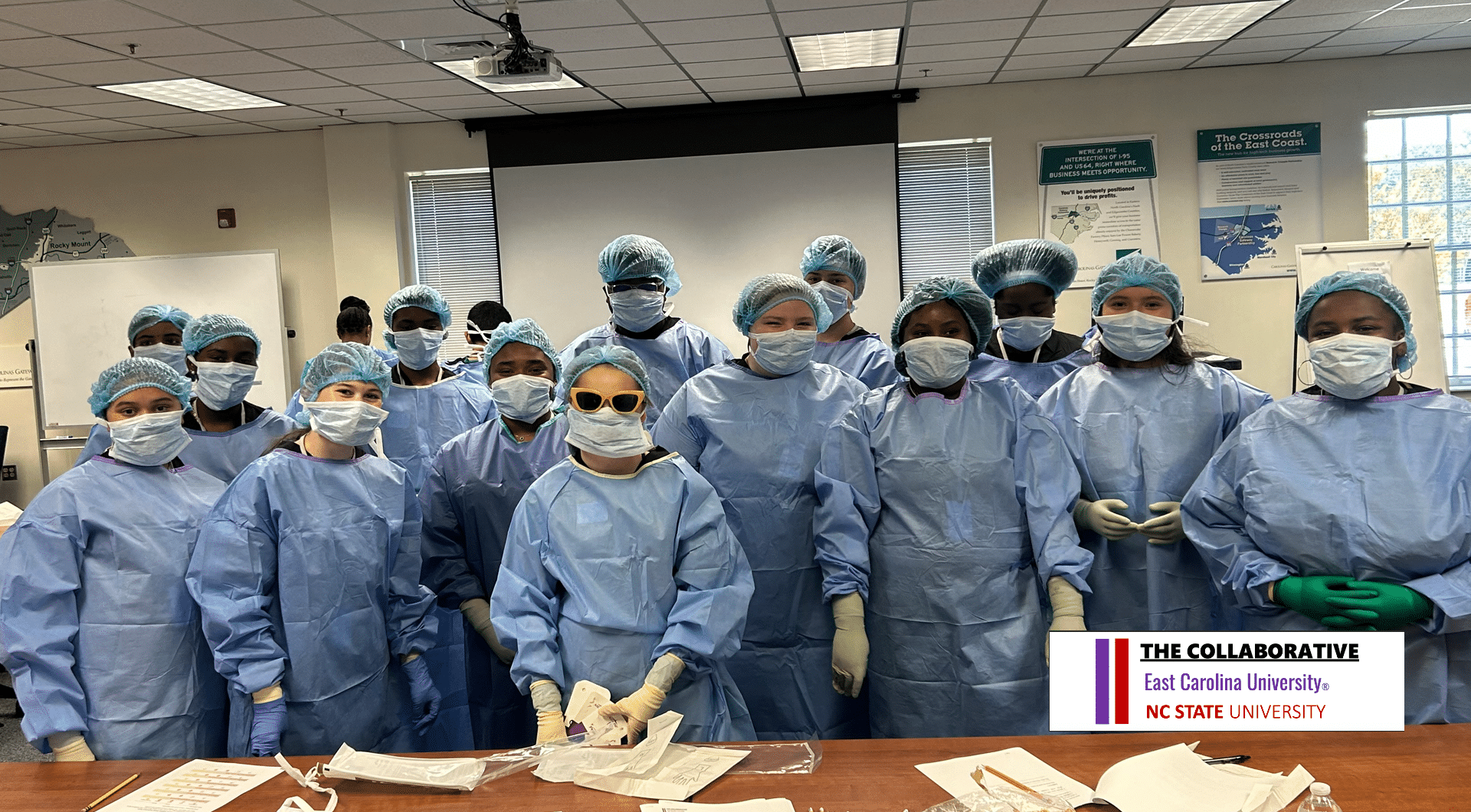 Students in scrubs smiling. 